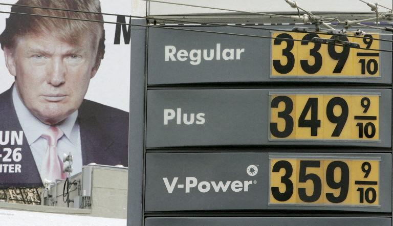 Le prix de l'essence est affiché sur un panneau dans une station-service Shell, tandis qu'une image de Donald Trump apparaît sur un panneau publicitaire à proximité, le 24 avril 2006 à San Francisco, en Californie.