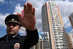 Un policier sécurise un périmètre autour d'un immeuble d'habitation endommagé après une attaque de drone signalée à Moscou.