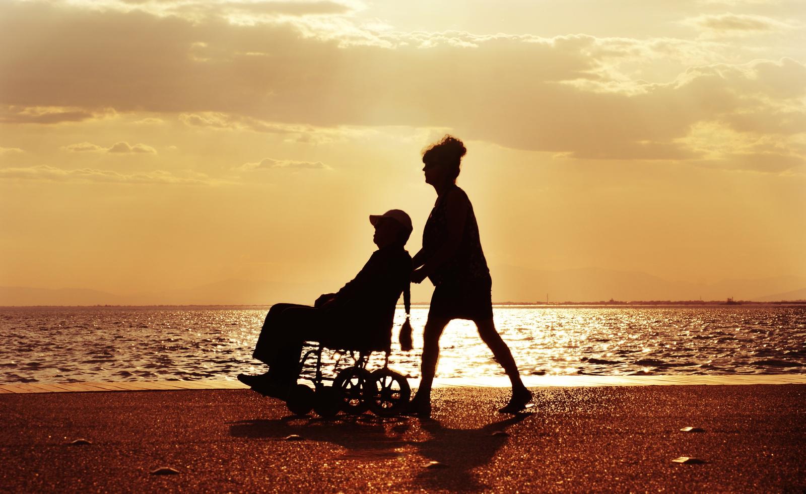Deux personnes se promènent sereinement sur la plage. (Image d'illustration)