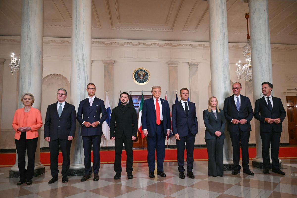 Ursula von der Leyen, Keir Starmer, Alexander Stubb, Volodymyr Zelensky, Donald Trump, Emmanuel Macron, Giorgia Meloni, Friedrich Merz et Mark Rutte posent pour une photo de famille dans le Cross Hall de la Maison Blanche à Washington, le 18 août 2025.