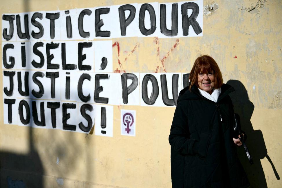 Gisèle Pelicot pose à côté d'un collage mural affichant le message « Justice pour Gisèle, justice pour toutes les femmes ! » lors du procès de son ancien compagnon, Dominique Pelicot, à Avignon, le 10 décembre 2024.
