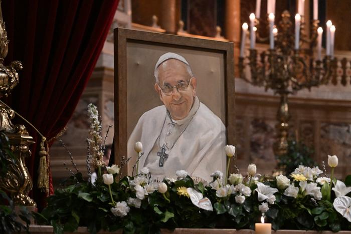 Un portrait du pape François est exposé devant l'autel alors que fidèles, prêtres et autres croyants se rassemblent le 23 avril 2025, dans la basilique Saint-Étienne de Budapest.