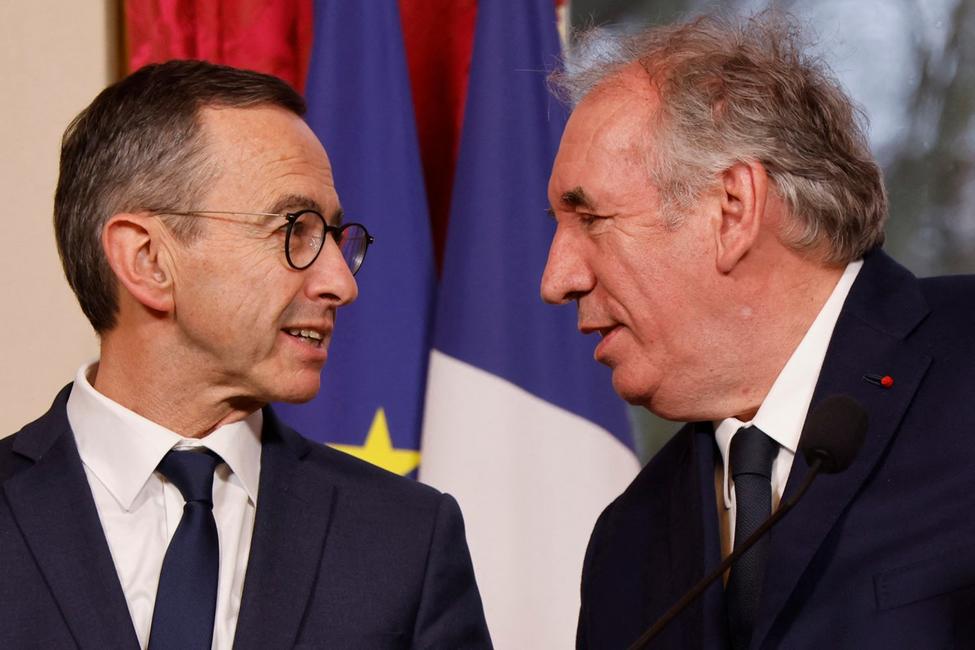 France's Prime Minister Francois Bayrou (R) addresses a speech with France's Minister of the Interior Bruno Retailleau after an Inter-ministerial Committee for Immigration Control (CICI-Comite interministeriel de controle de l'immigration) meeting at the Hotel Matignon in Paris on February 26, 2025. (Photo by Ludovic MARIN / AFP)