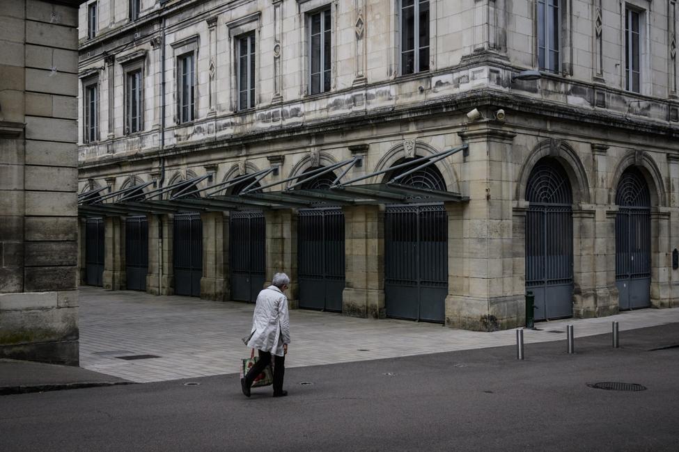 Une femme passe devant une halle fermée dans la ville de Clamecy, touchée par la désertification, dans le centre de la France, le 17 avril 2025.