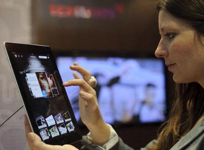 Une femme teste l'application de lecture de livres numériques Textunes sur un iPad d'Apple lors du Salon du livre de Leipzig.
