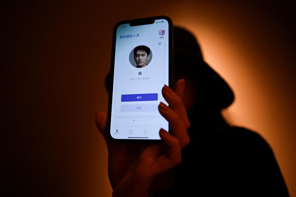 Une jeune femme montre sur son téléphone portable, à Pékin, son petit ami virtuel - un chatbot créé par XiaoIce, un système d'intelligence artificielle de pointe conçu pour tisser des liens émotionnels avec son utilisateur.