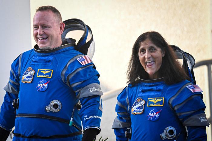 NASA astronauts  Butch Wilmore (R) and Suni Williams, wearing Boeing spacesuits,  depart the Neil A. Armstrong Operations and Checkout Building at Kennedy Space Center for Launch Complex 41 at Cape Canaveral Space Force Station in Florida to board the Boeing CST-100 Starliner spacecraft for the Crew Flight Test launch, on June 5, 2024. Boeing on June 5 will try once more to launch astronauts aboard a Starliner capsule bound for the International Space Station. Liftoff is targeted for 10:52 am (1452 GMT) for a roughly one-week stay at the orbital laboratory. (Photo by Miguel J. Rodriguez Carrillo / AFP)