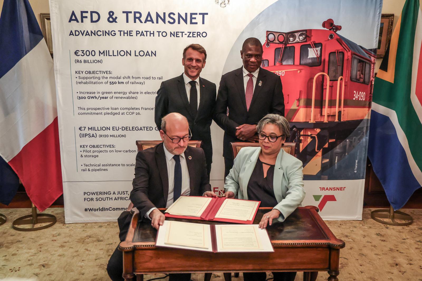 Emmanuel Macron et le vice-président sud-africain Paul Mashatile observent le directeur général de l'Agence française de développement (AFD), Rémy Rioux serrer la main de la PDG du groupe Transnet, Michelle Phillips, à l'occasion du lancement du Conseil d'affaires franco-sud-africain, à la résidence de l'ambassadeur de France en Afrique du Sud à Pretoria, le 21 novembre 2025, en amont du sommet des dirigeants du G20.