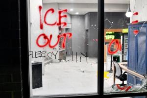 Des graffitis et une vitre brisée sont visibles lors de la manifestation « ICE OUT ! Noise Demo » organisée par des manifestants dans un hôtel de Minneapolis, dans le Minnesota, le 25 janvier 2026.
