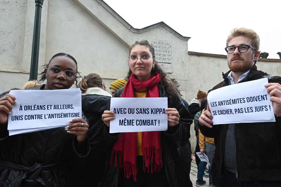 Des manifestants brandissent des pancartes où l’on peut lire (de g. à dr.) « À Orléans et ailleurs, unis contre l’antisémitisme », « Avec ou sans kippa, même combat » et « Ce sont les antisémites qui doivent se cacher, pas les Juifs », devant la synagogue d’Orléans, avant une marche silencieuse de soutien au rabbin d’Orléans, à Orléans (centre de la France), le 25 mars 2025. (Image d'illustration)